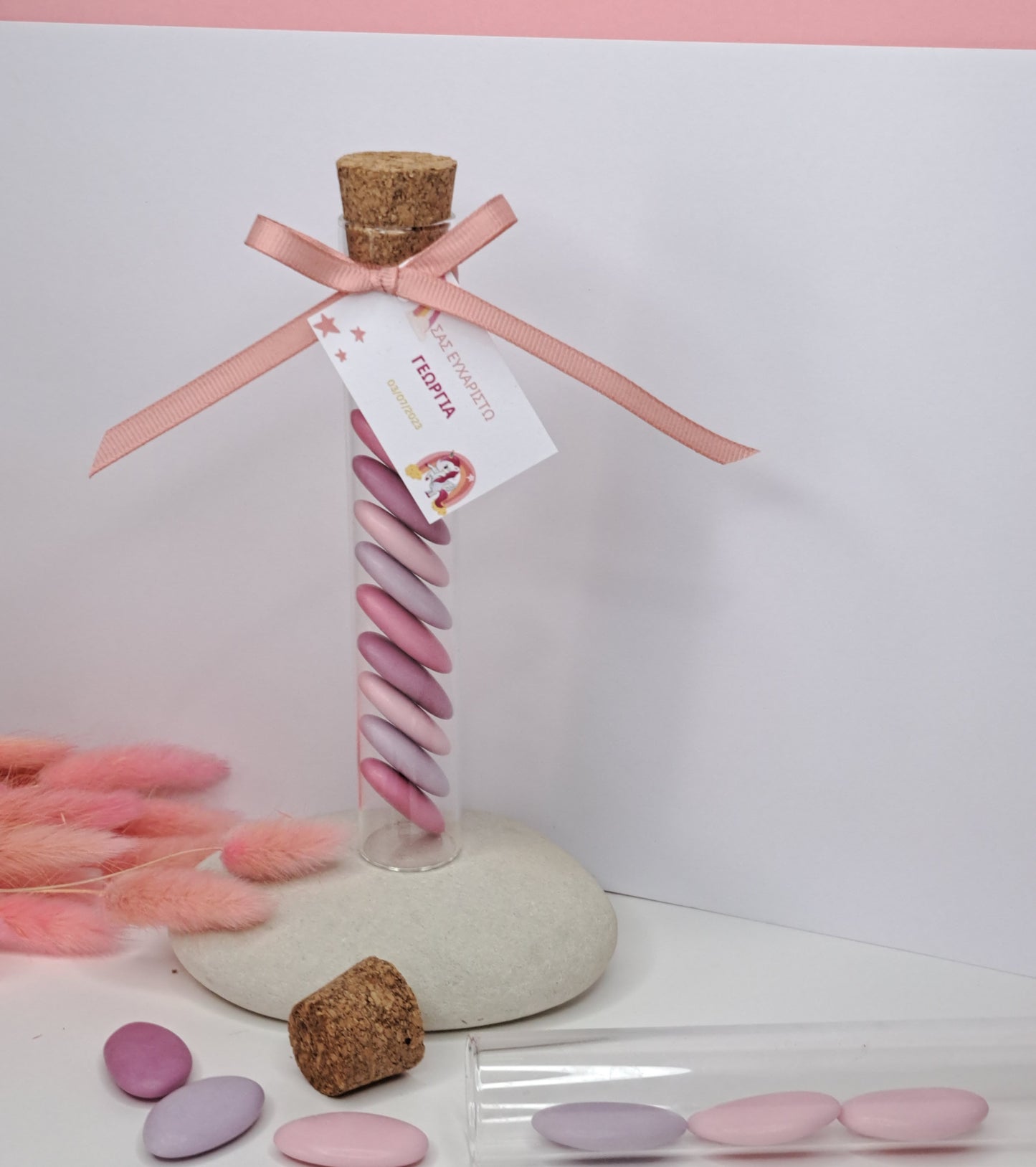 Glass tube with pink candy
