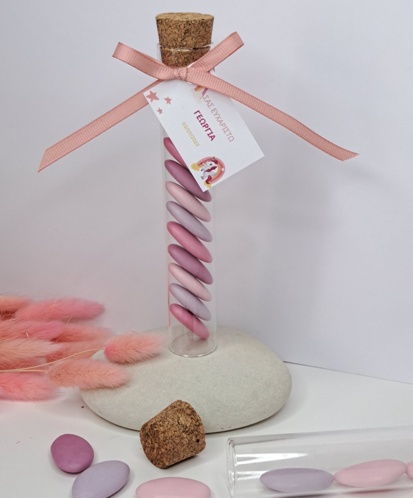 Glass tube with pink candy