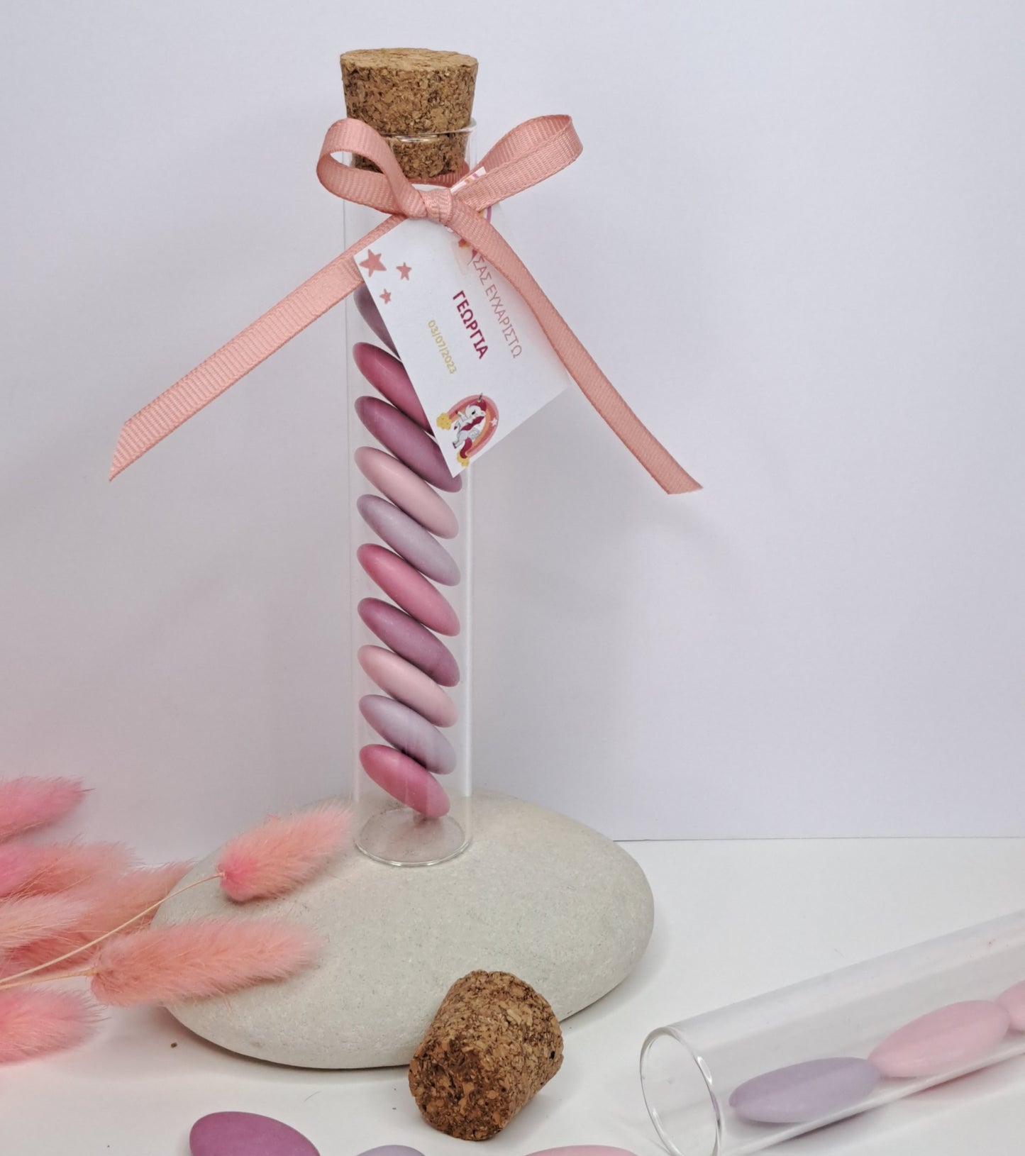 Glass tube with pink candy