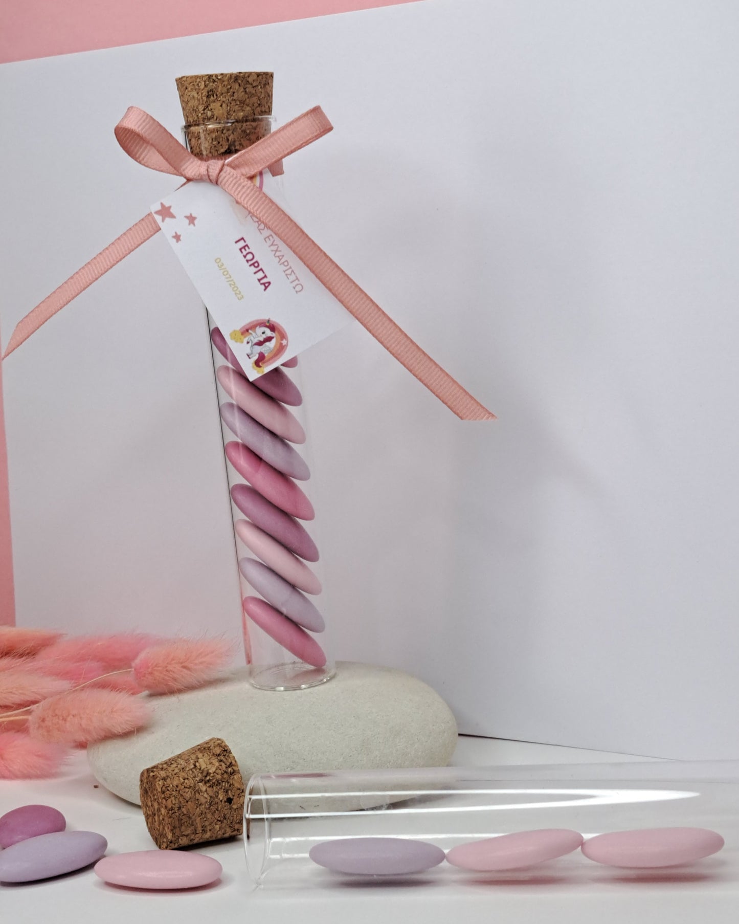 Glass tube with pink candy
